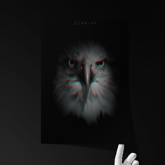 Fine art print titled ‘CLARITY’ showing a frontal eagle portrait with intense eyes and subtle 3D glitch effects, held by a hand against a dark background.