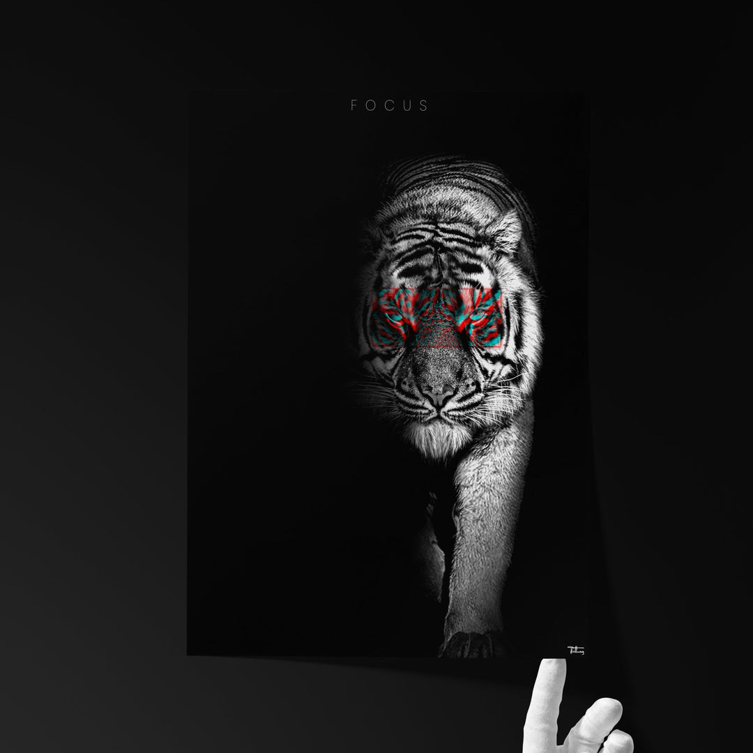 Fine art print titled ‘FOCUS’ featuring a black-and-white tiger with red-accented eyes, held by a hand against a dark background.