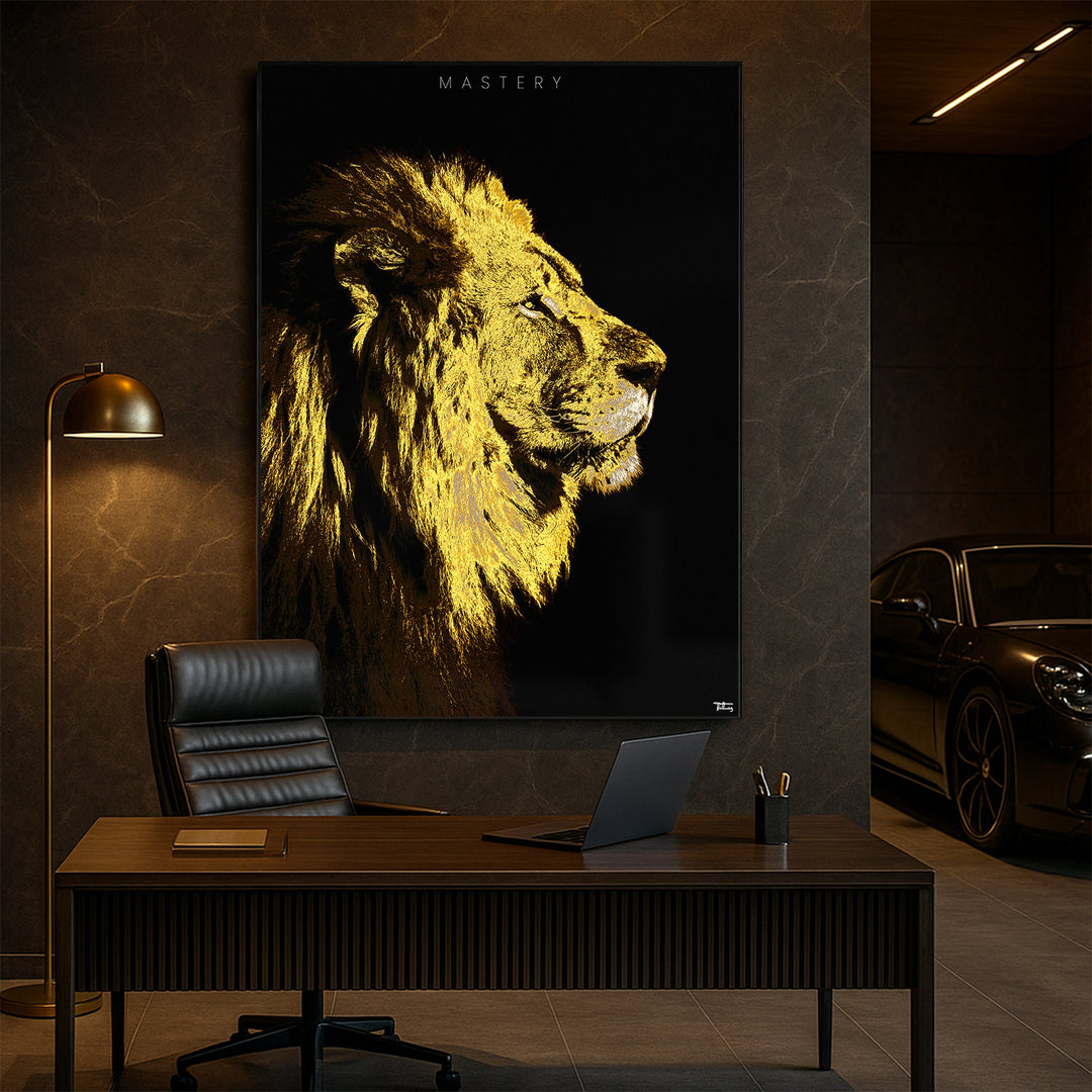 Golden lion fine art print with radiant fur detail, titled ‘MASTERY’, showcased on a textured dark wall in a sophisticated office setting with a luxury car nearby.