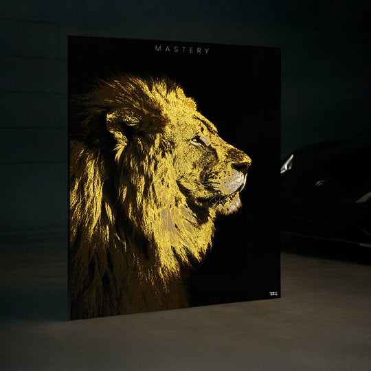 Framed ‘MASTERY’ lion fine art print displayed in a luxury space near a high-end car, emphasizing strength and regal aesthetic.